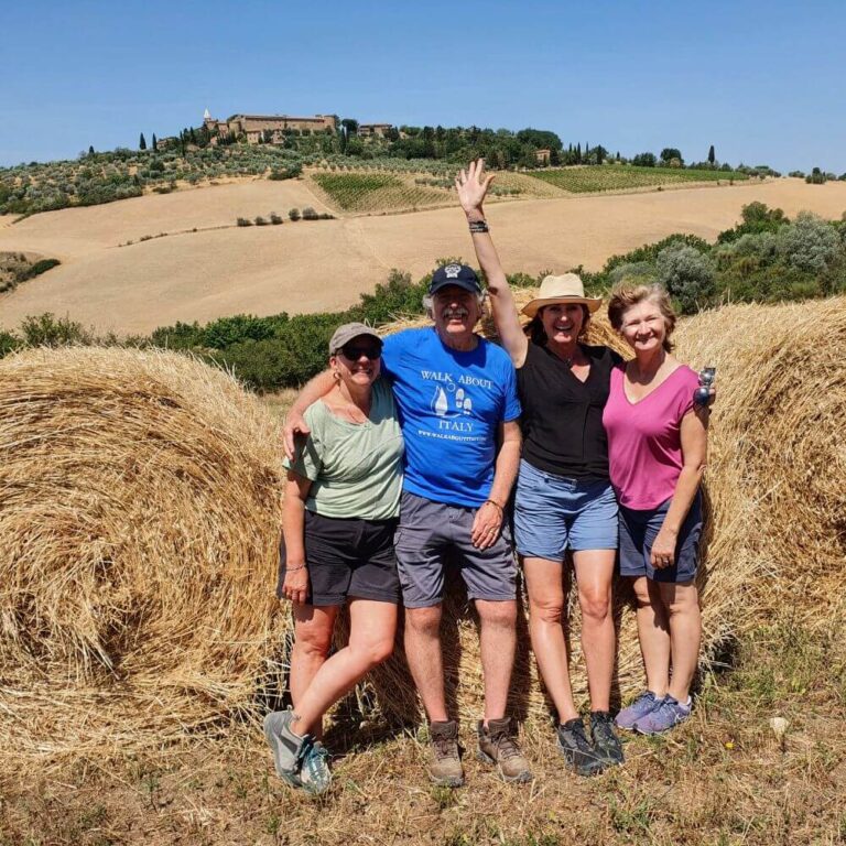 Small group photo in the Tuscan hills with hay bales and rolling countryside