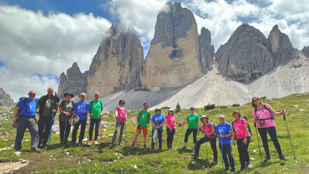 A Walk About Italy group smiling in front of the Tre Cime di Lavaredo in the Dolomites