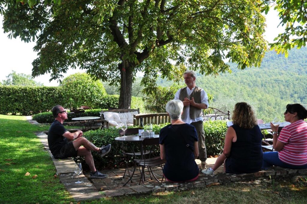 Dario explaining the virtues of this unique area to our group over a glass of white wine (Iconic Tuscany walking tour with Walk About Italy)