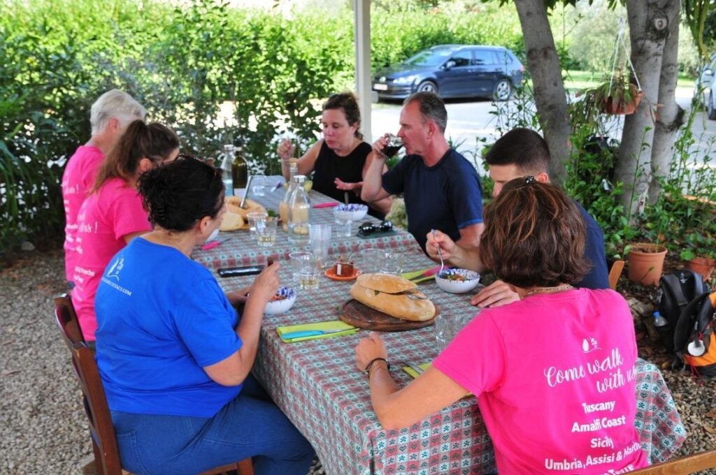 The group lunching at the Ganozzi farm, wearing our "Walk About Italy" T shirts (Iconic Tuscany walking tour with Walk About Italy)
