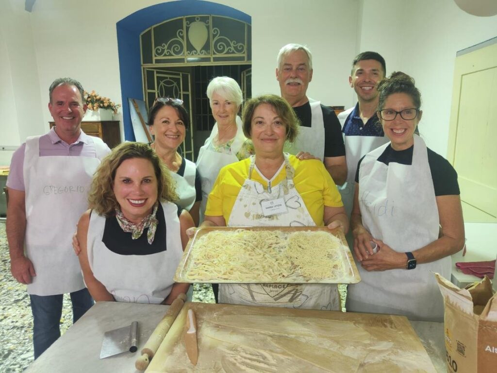 Our group with the "capo donna della cucina" and our finished pasta (Iconic Tuscany walking tour with Walk About Italy)
